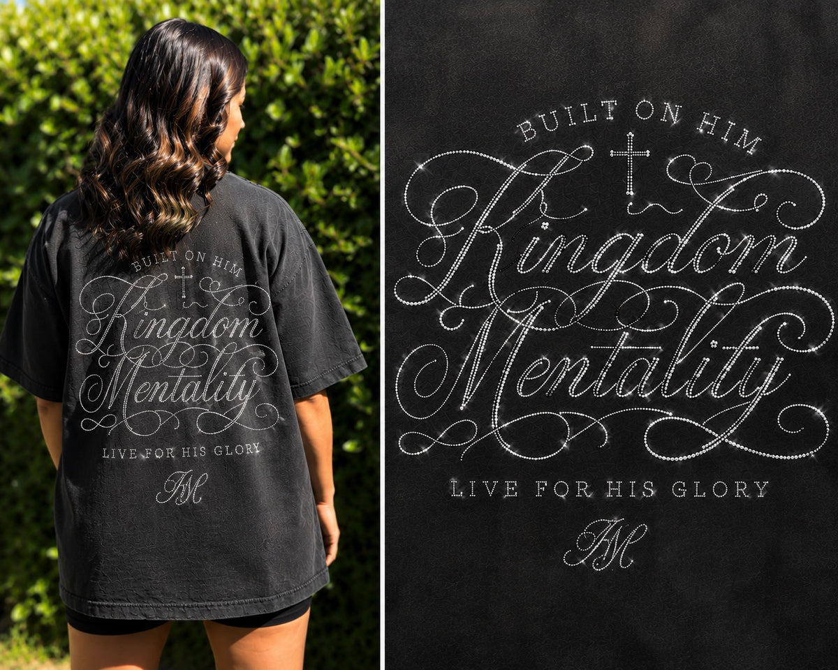 Model wearing a black Kingdom Mentality Christian T-shirt featuring a faith-inspired back graphic with rhinestone detailing. 