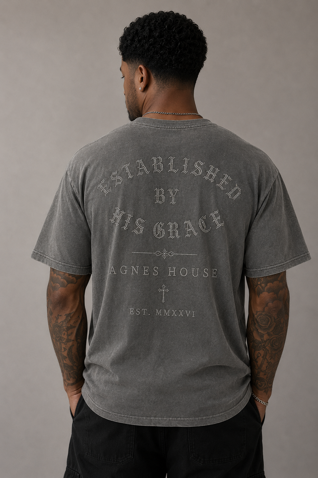 Model wearing a gray oversized Established by His Grace Christian T-Shirt with faith-inspired back graphic