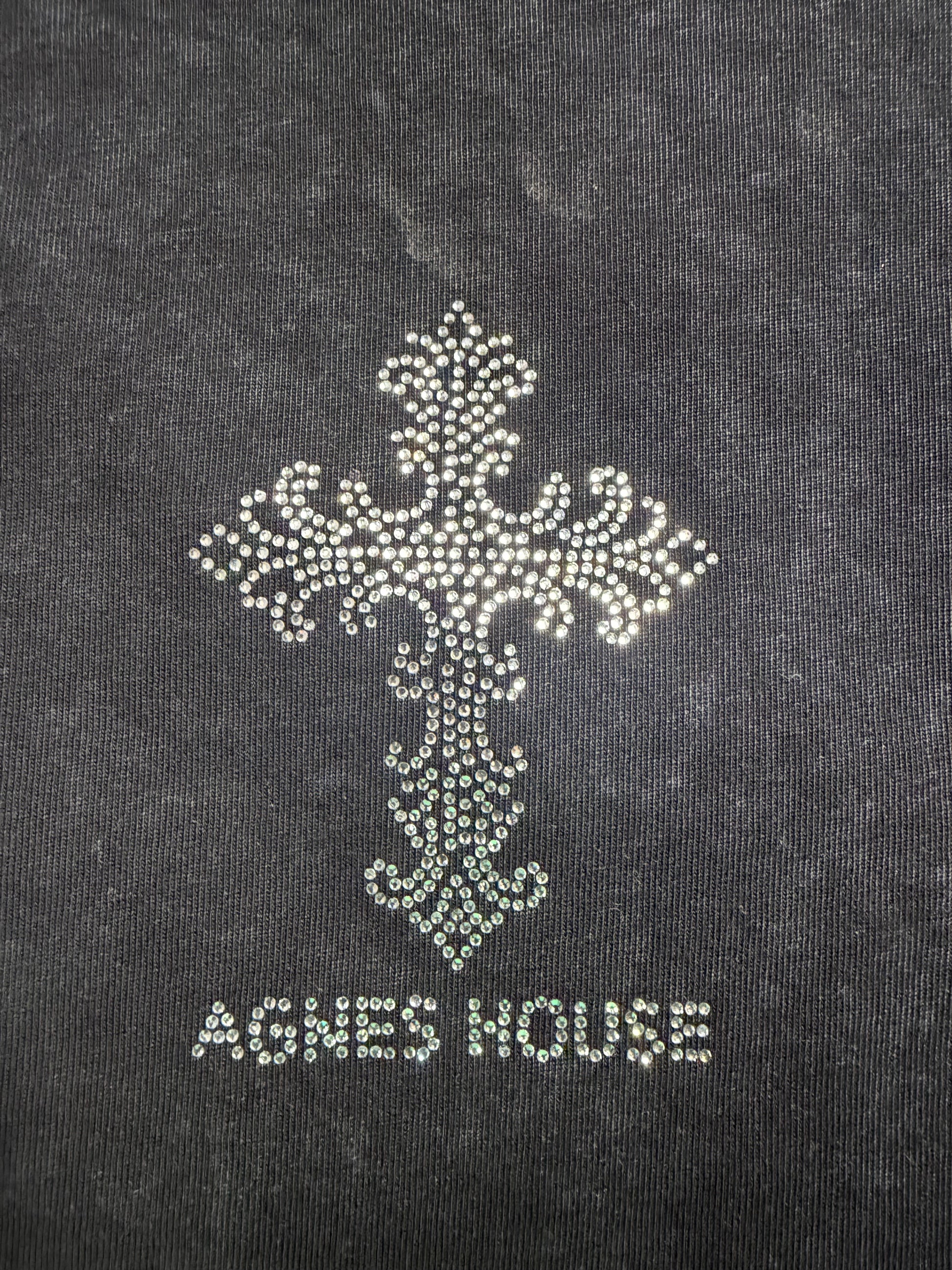 Close-up of large crystal rhinestone cross and Agnes House lettering on the black washed T-shirt